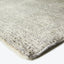 Close-up of a soft, plush rug in light neutral color.