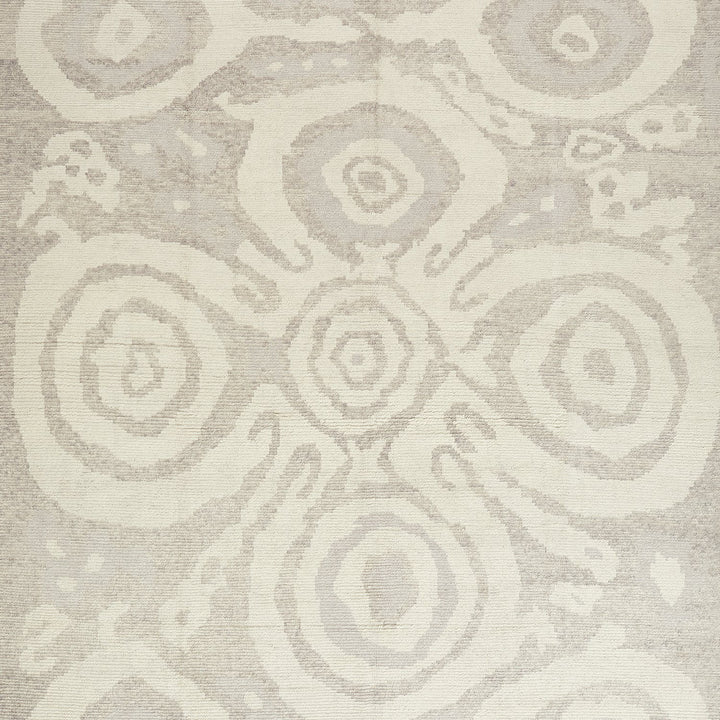 Neutral-toned fabric or carpet with organic-inspired spiral motifs.