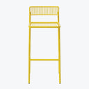 Minimalist yellow metal bar stool adds a pop of color.