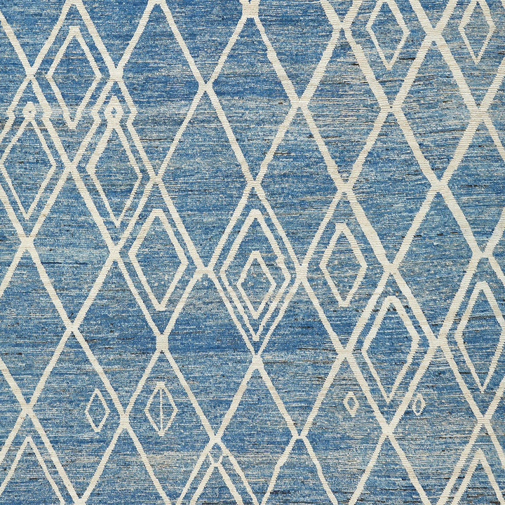 Ethnic-inspired geometric textile featuring a distressed blue background and diamonds pattern