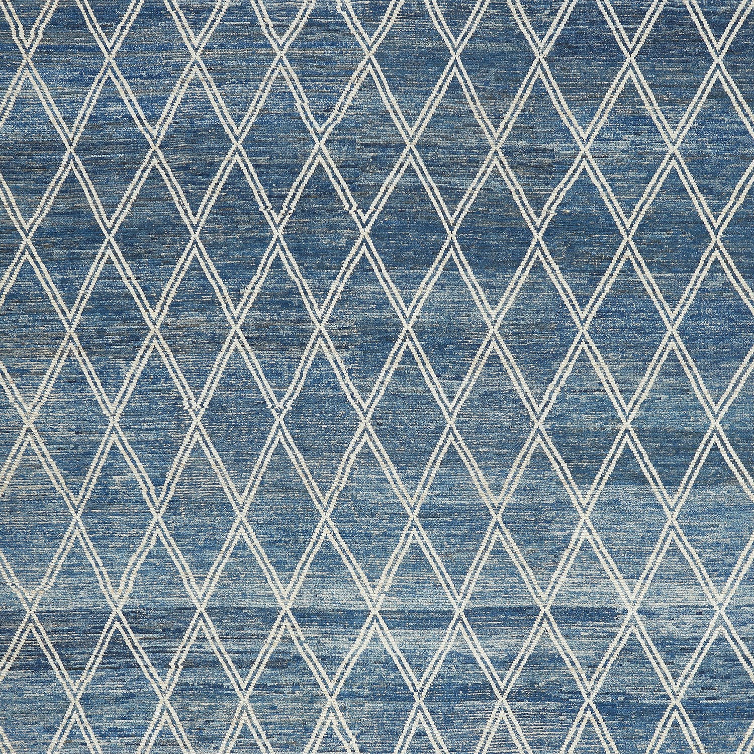 Textured denim fabric with white diamond pattern, perfect for decor.