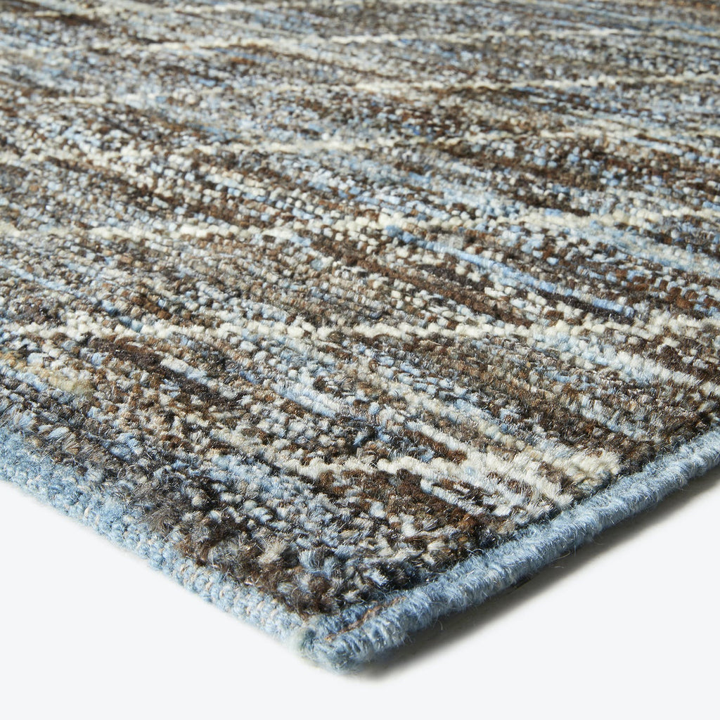 Close-up of a striped rug showcasing textured fibers and colors.