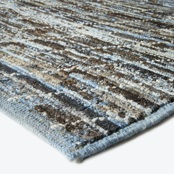 Close-up view of a textured rug with earthy brown stripes