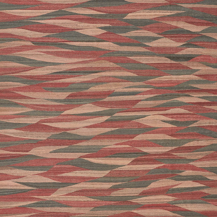 Close-up of a textured carpet with dynamic, abstract wave pattern.