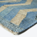 Close-up of a plush, handcrafted woven rug with geometric pattern