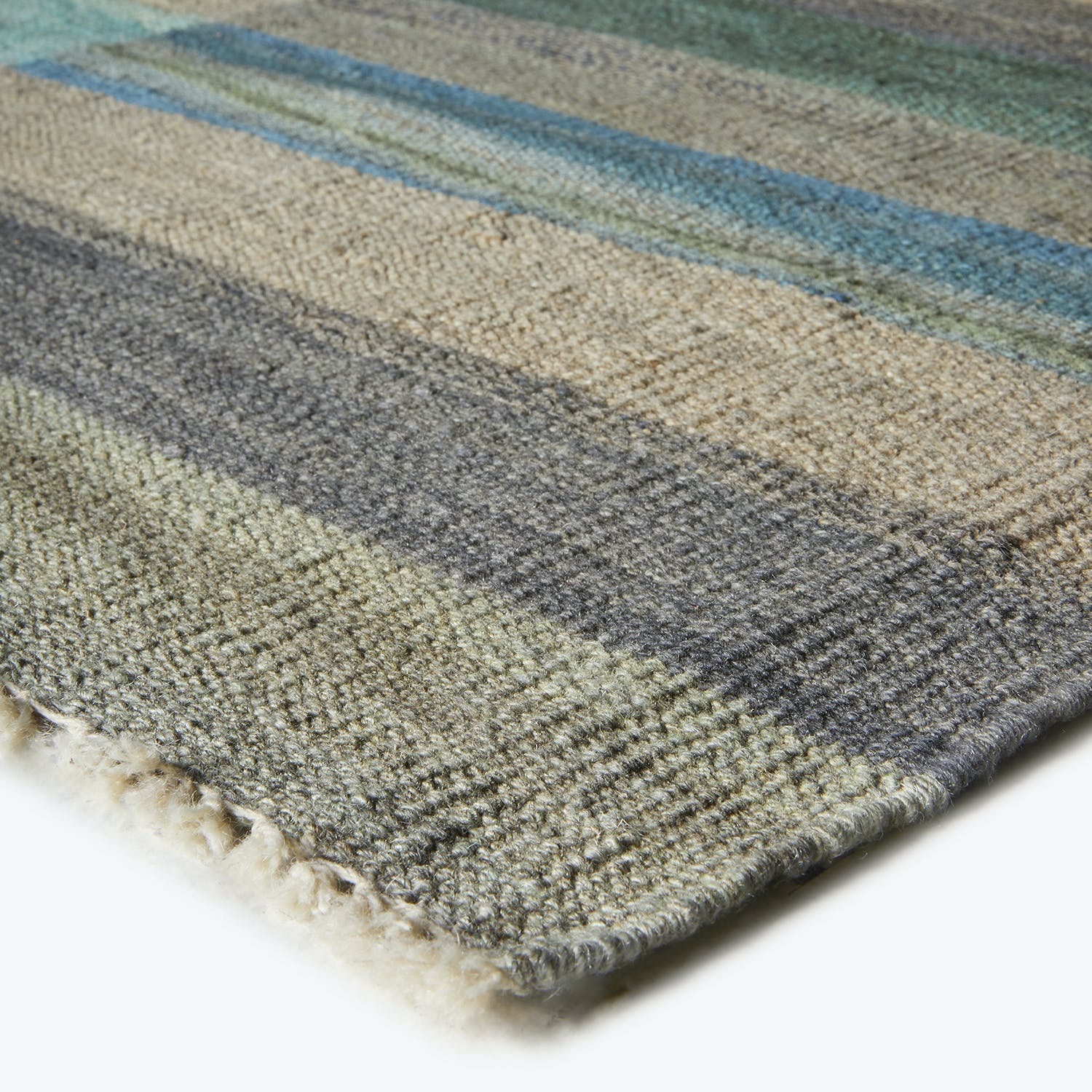 Close-up of a soft, thick rug with colorful horizontal stripes.