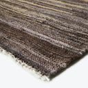 Close-up view of a striped textile with brown shades and texture.