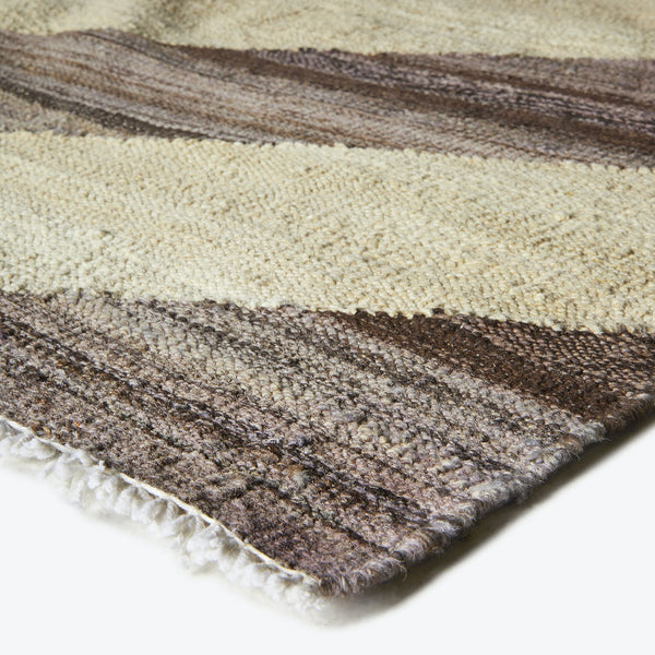 Close-up of a plush, gradient-colored rug with looped fibers.