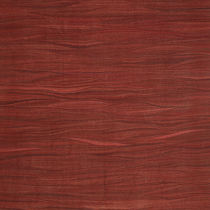 Close-up view of rich red wood texture with natural grain patterns.