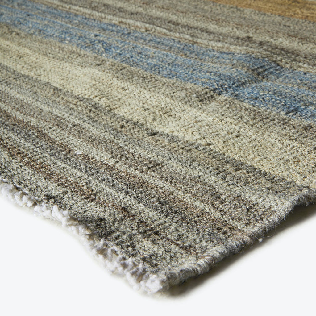 Close-up shot of a textured rug with subtle color gradients.