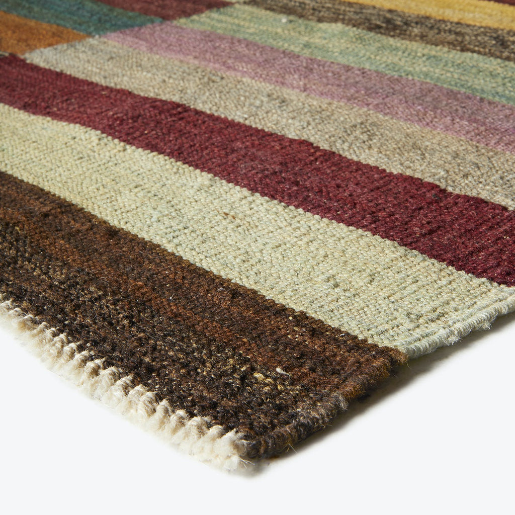 Close-up of a textured, striped fabric showcasing various earthy tones.