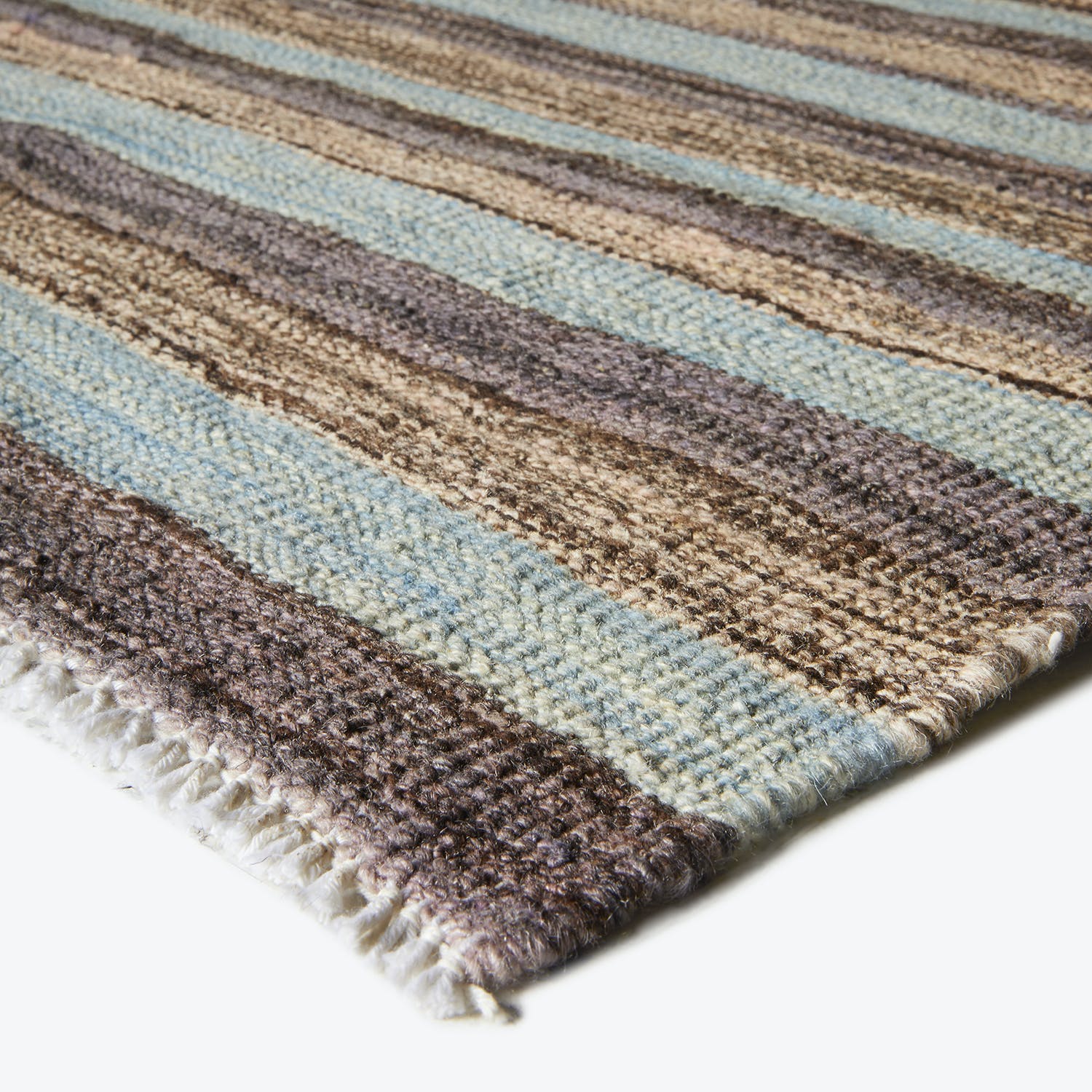 Close-up of a plush striped rug with soft, thick texture.