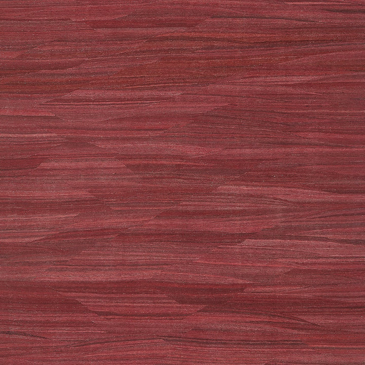 A close-up of a red wooden surface with distinct grain pattern.
