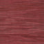 A close-up of a red wooden surface with distinct grain pattern.