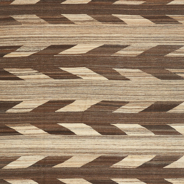 Close-up of a herringbone patterned surface with alternating dark and light shades.