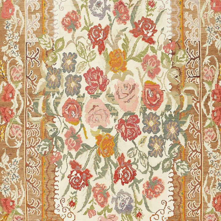 Intricate floral pattern with roses and spiraling designs on textile.