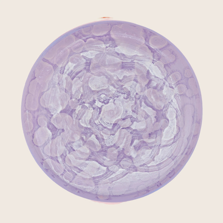 Abstract artwork by J. Queen showcases textured purple hues in circular form