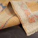 Close-up of handcrafted, textured rug with warm, inviting tones.