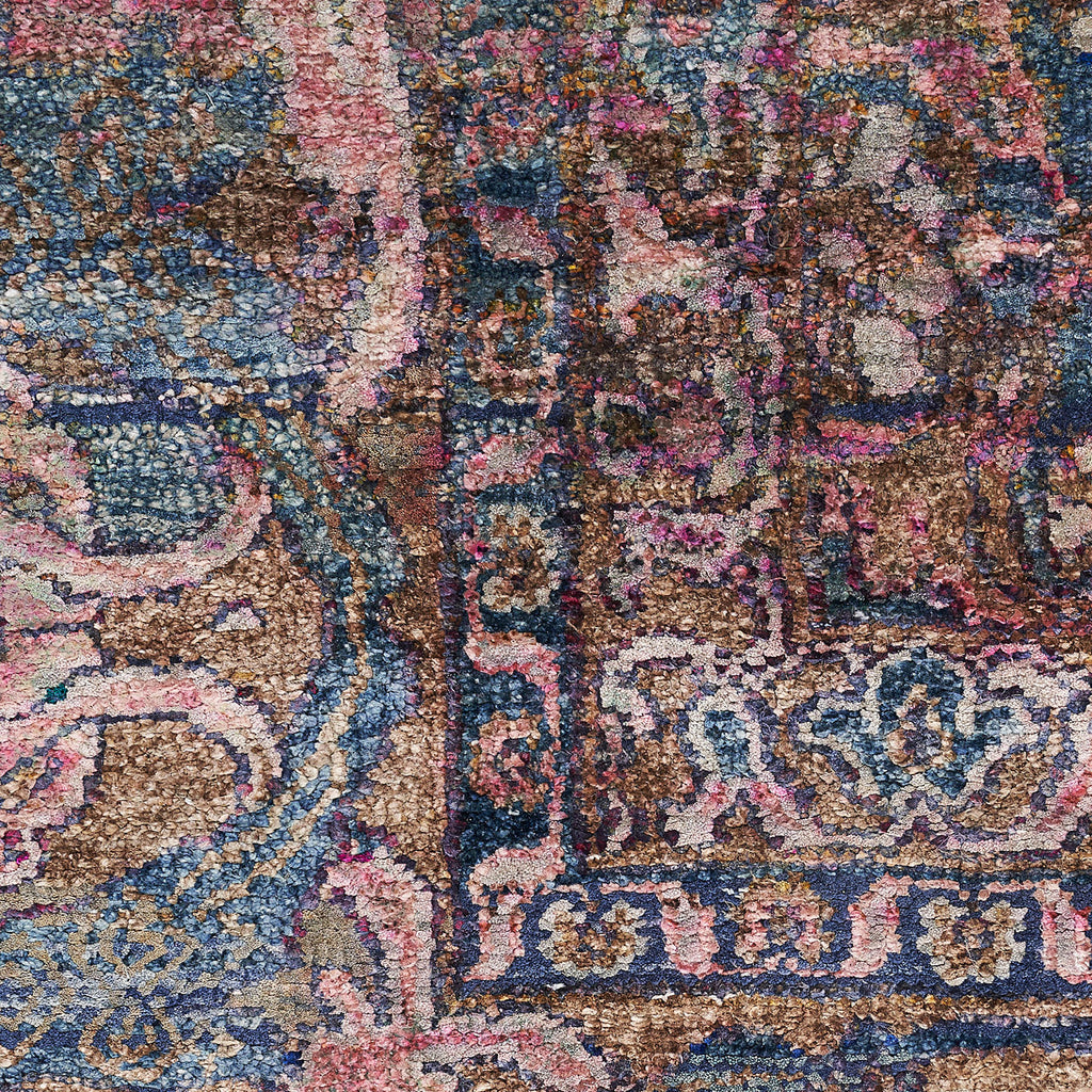 Close-up of intricately designed, richly textured and colorful carpet.
