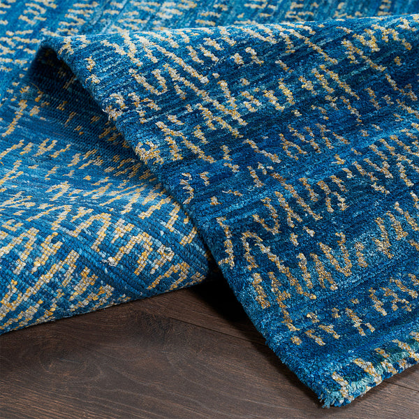 Close-up of a vibrant blue rug with modern geometric pattern.