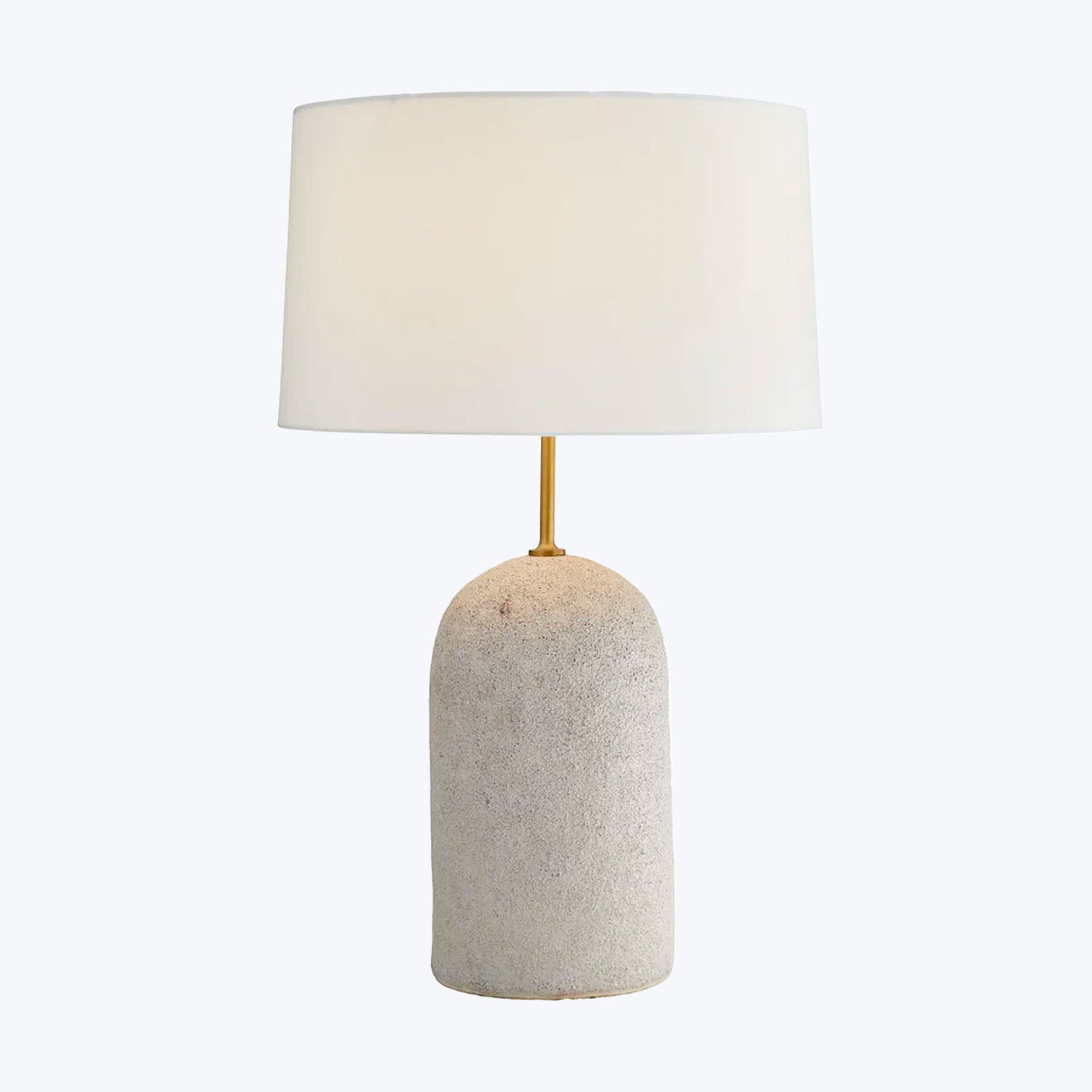Contemporary table lamp with textured stone base and soft lighting.