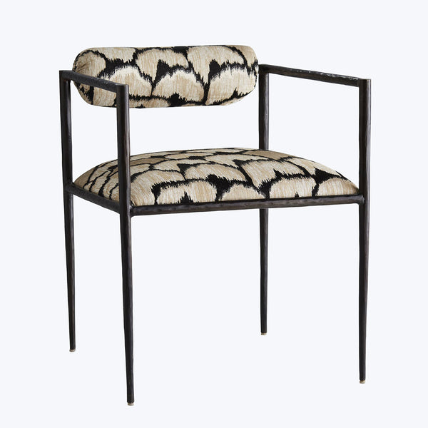 Modern armchair with industrial metal frame and bold patterned fabric