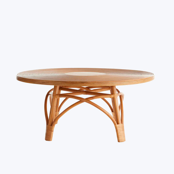 Round wooden table with textured concentric circles and curved base.