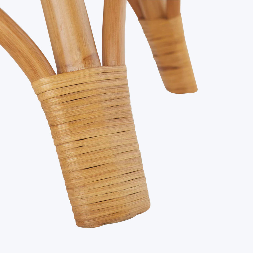 Close-up view of a handcrafted wooden object with wrapped handle.