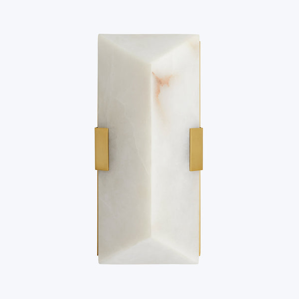 Elegant alabaster light fixture with gold brackets emits warm illumination.