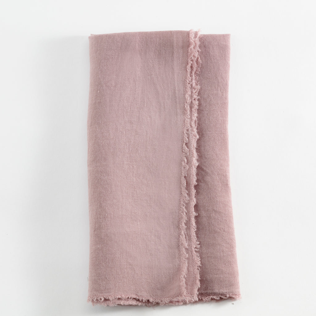Soft dusty pink cloth napkin with delicate lace border.