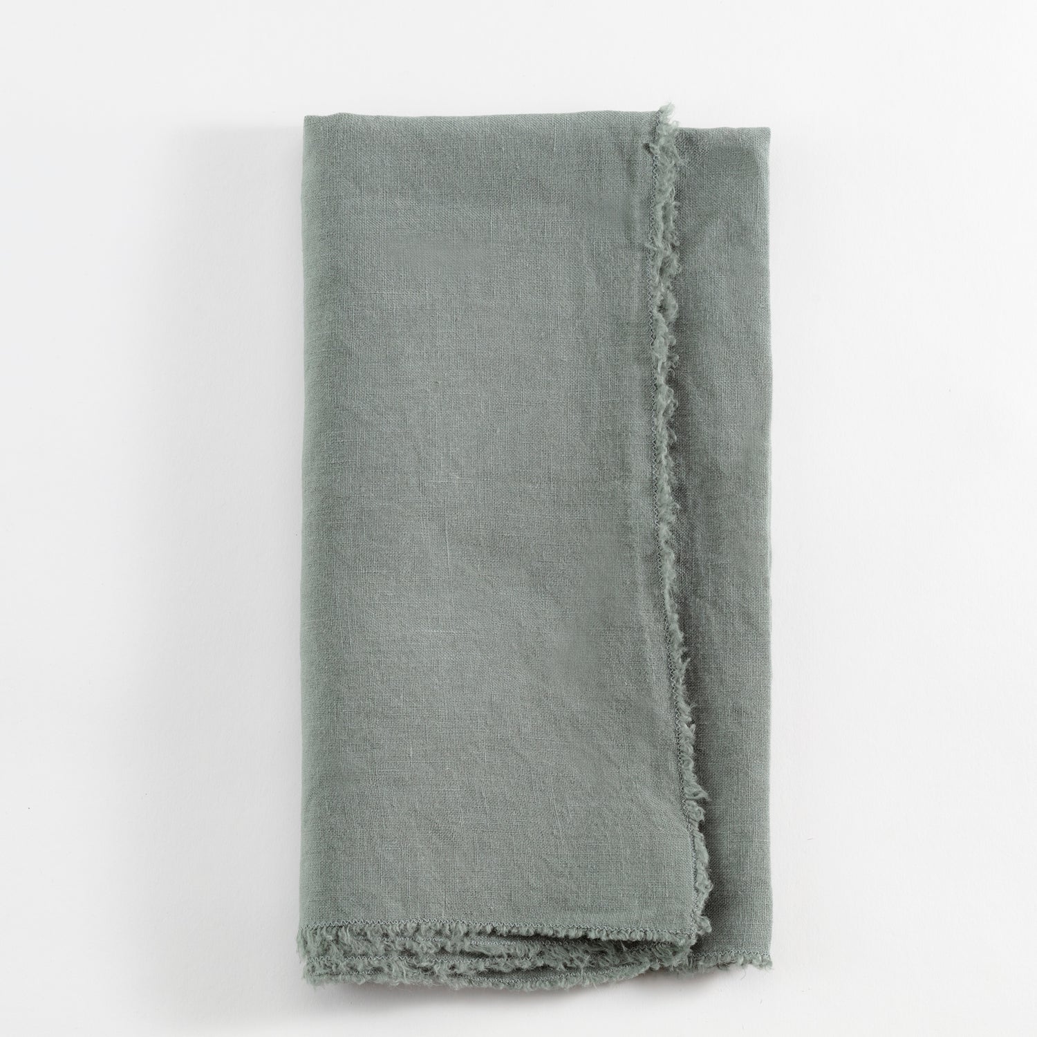 Frayed linen cloth in muted green or gray with rustic charm.