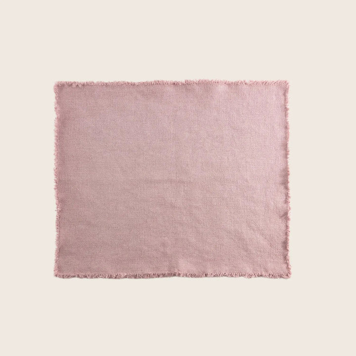 Light pink fabric with frayed edges, textured surface, no prints.