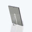 Minimalistic freestanding mirror with clear acrylic frame and adjustable stand.