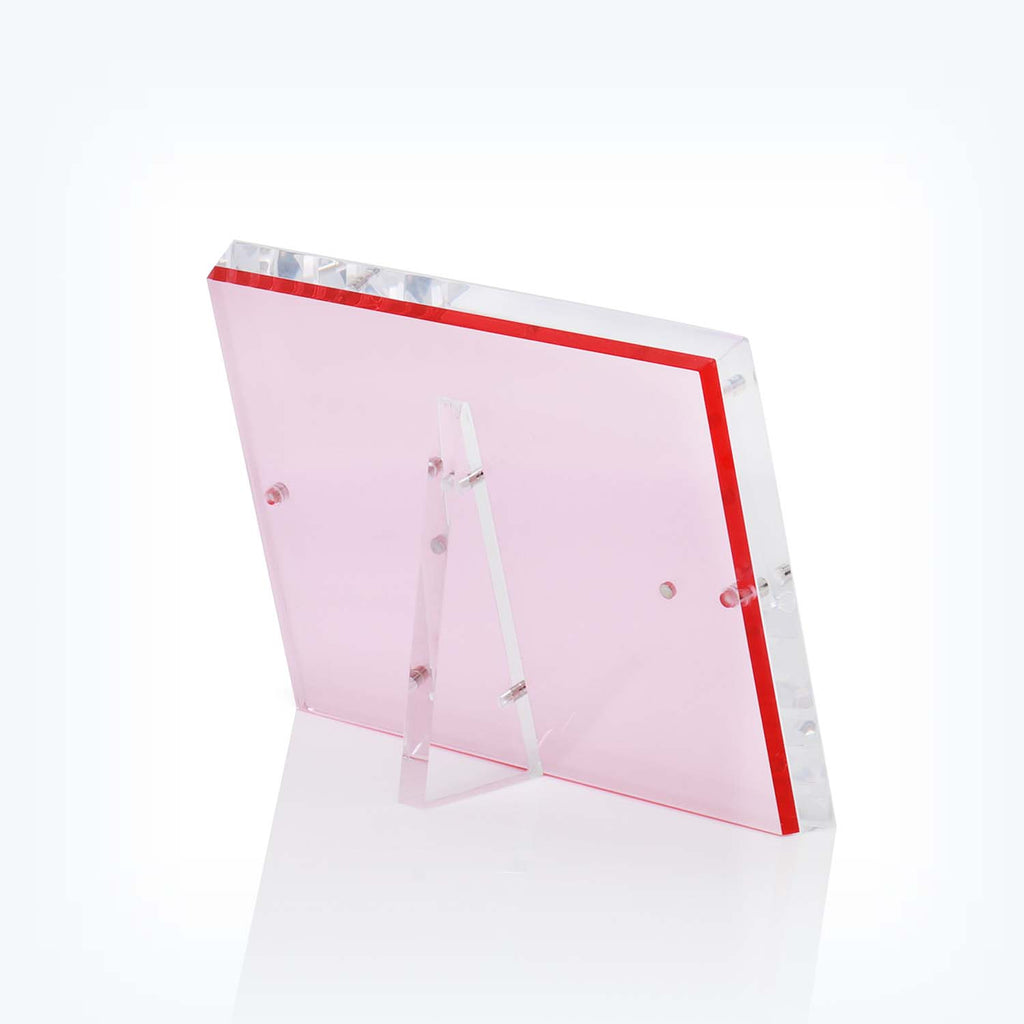 Sleek pink acrylic panel with vibrant red border and stand.