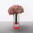 An elegant arrangement of lush pink peonies in a clear vase.