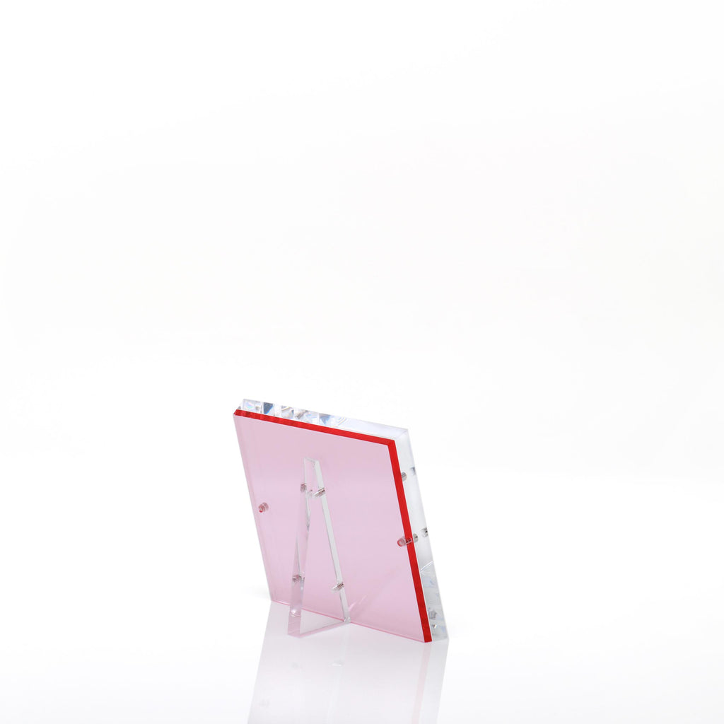 Contemporary acrylic photo frame with pink accents exudes minimalist elegance.