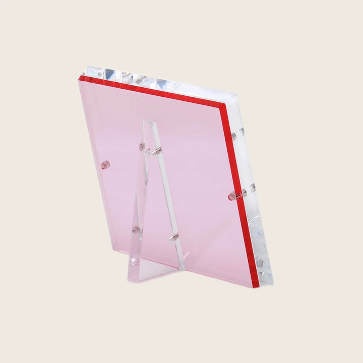 Transparent pink acrylic award with beveled edges and red border.