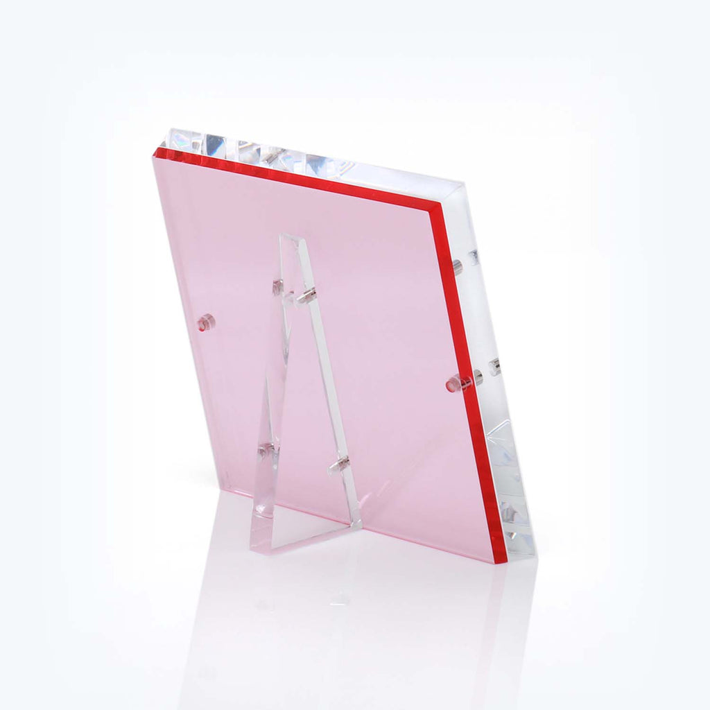 Transparent pink acrylic award with beveled edges and red border.
