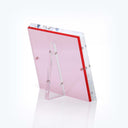 Transparent pink acrylic award with beveled edges and red border.