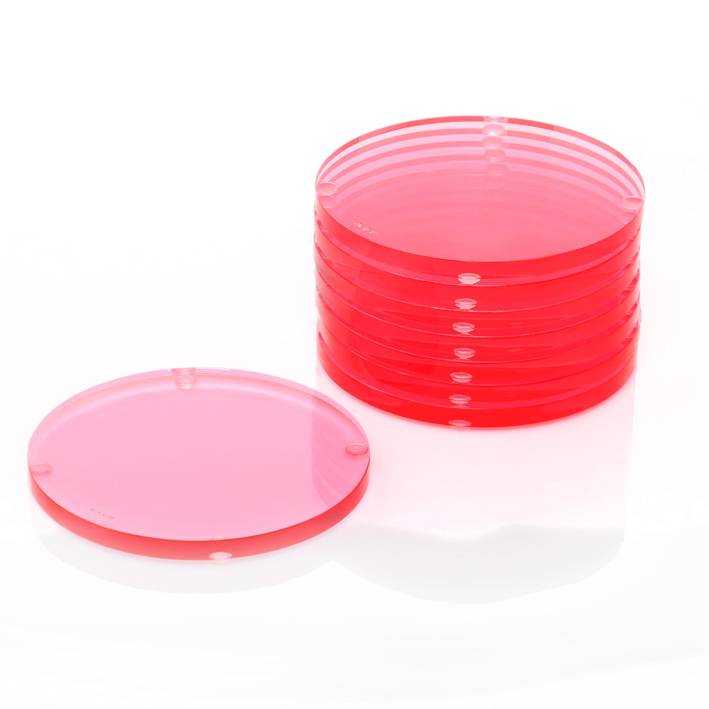 Stack of red Petri dishes with one lid separated in foreground.
