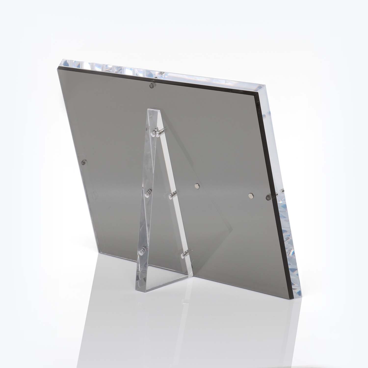 Clear acrylic stand supports rectangular mirror with beveled edge.