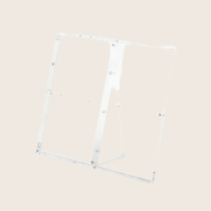 Minimalist and modern clear acrylic easel against a white background.