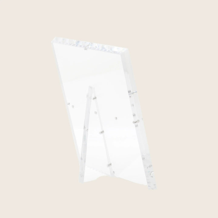Minimalistic acrylic easel with raised edge for secure display.