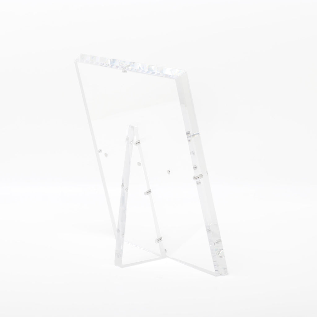 Minimalistic acrylic easel with raised edge for secure display.