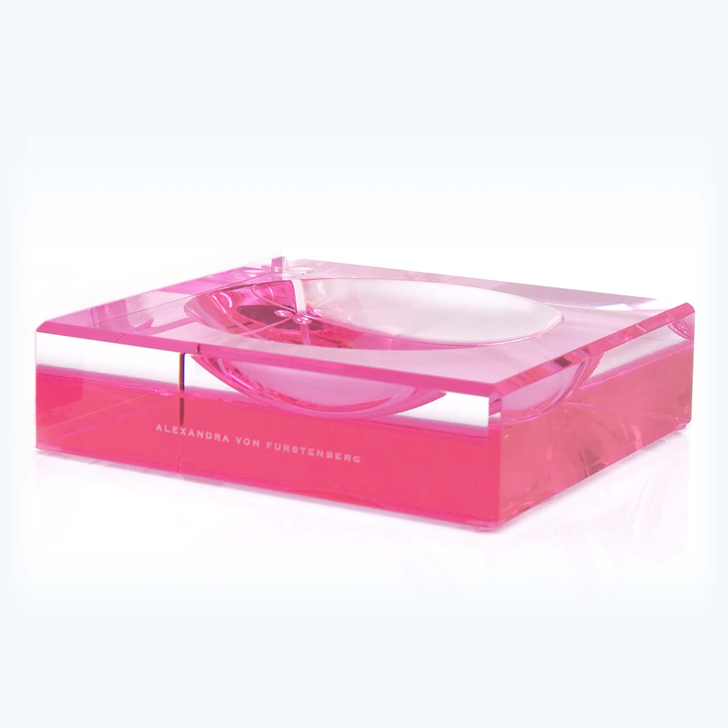 Contemporary pink acrylic ashtray with minimalist design and Alexandra von Furstenberg branding.