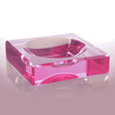 Minimalist pink acrylic box with magnifying function and reflective surface.