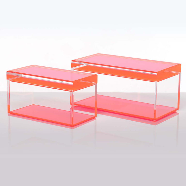 Two modern acrylic tables with a transparent reddish appearance.