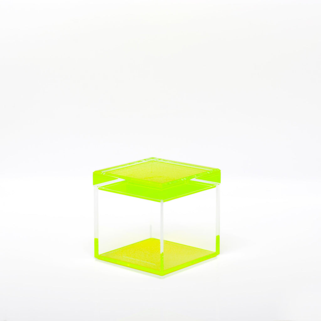 Minimalist fluorescent lime-green side table with clean lines and symmetry.