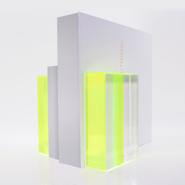 Neon yellow-green acrylic awards showcased, symbolizing recognition and achievement.