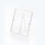 Transparent acrylic display stand with folding back support on white background.